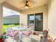 Covered patio with ceiling fan and elegant table set, for outdoor relaxation at 120 Grove Branch Rd, Winter Haven, FL 33880