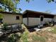 Back view of house with a screened-in porch and an unkempt yard at 1208 Lowry Ave, Haines City, FL 33844