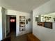 Hallway with tile flooring and decorative shelving, leading to various rooms at 1208 Lowry Ave, Haines City, FL 33844