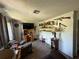 Cozy living room features tile flooring, decorative shelving and natural light at 1208 Lowry Ave, Haines City, FL 33844