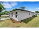 Exterior side view of this home, featuring a walkway and tasteful landscaping at 1242 Dorothy St, Lakeland, FL 33815