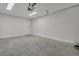 An empty garage with clean painted walls, concrete floors and an entry door at 1242 Dorothy St, Lakeland, FL 33815