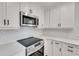 Modern kitchen featuring stainless steel appliances and white cabinetry at 1242 Dorothy St, Lakeland, FL 33815
