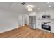 Open-concept kitchen featuring stainless steel appliances and hardwood floors at 1242 Dorothy St, Lakeland, FL 33815