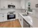 Clean modern kitchen featuring white cabinets, stainless steel appliances and backsplash at 1242 Dorothy St, Lakeland, FL 33815