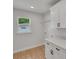 Clean laundry room with storage cabinets and a window at 1242 Dorothy St, Lakeland, FL 33815