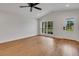 Bright living room with wood floors, ceiling fan and window with outside view at 1242 Dorothy St, Lakeland, FL 33815