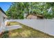 Backyard featuring a white fence and newly installed sod at 1246 Dorothy St, Lakeland, FL 33815