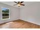 Bright bedroom with hardwood floors, ceiling fan, and a large window offering ample natural light at 1246 Dorothy St, Lakeland, FL 33815