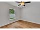 Bright bedroom with hardwood floors, ceiling fan, and a large window offering ample natural light at 1246 Dorothy St, Lakeland, FL 33815