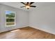 Bright bedroom with hardwood floors, ceiling fan, and a large window offering ample natural light at 1246 Dorothy St, Lakeland, FL 33815