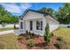 Exterior of a white single-story home featuring a gray garage door and well-manicured lawn at 1246 Dorothy St, Lakeland, FL 33815