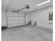 Spacious garage with a roll-up door, painted walls, and a clean, concrete floor at 1246 Dorothy St, Lakeland, FL 33815