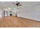 Bright living room with hardwood floors adjacent to a modern kitchen featuring stainless steel appliances at 1246 Dorothy St, Lakeland, FL 33815