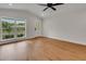 Bright living room with hardwood floors, a large window, and a glass door showcasing the home's exterior at 1246 Dorothy St, Lakeland, FL 33815