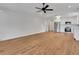Bright living room with hardwood floors adjacent to a modern kitchen featuring stainless steel appliances at 1246 Dorothy St, Lakeland, FL 33815