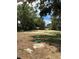Landscaped backyard with mature trees and a well cover at 1329 Tom Watson Rd, Lakeland, FL 33801