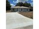 Charming single-story home with a spacious concrete driveway at 1329 Tom Watson Rd, Lakeland, FL 33801