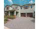Charming two-story home featuring a two-car garage, covered porch, and inviting curb appeal at 13525 Gorgona Isle Dr, Windermere, FL 34786