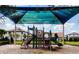 Community playground featuring slides and climbing structures, with residential buildings visible in the background at 13525 Gorgona Isle Dr, Windermere, FL 34786
