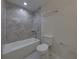 Clean bathroom with tub and shower combination and gray tile at 1415 Southern Ave, Lakeland, FL 33803