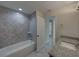 Modern bathroom with tub and shower combination and granite topped vanity at 1415 Southern Ave, Lakeland, FL 33803