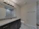 Stylish bathroom featuring dark vanity with marble countertop, gray tile and modern lighting at 1415 Southern Ave, Lakeland, FL 33803
