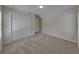 A bright carpeted bedroom featuring closet with doors and access to other rooms at 1415 Southern Ave, Lakeland, FL 33803
