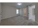 Spacious bedroom offers a window, neutral walls, plush carpeting, and an en-suite bathroom at 1415 Southern Ave, Lakeland, FL 33803