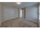 A carpeted bedroom featuring a large closet with white doors and neutral walls at 1415 Southern Ave, Lakeland, FL 33803