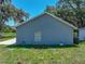 The rear exterior of a gray house shows a well-maintained lawn and clean design at 1415 Southern Ave, Lakeland, FL 33803