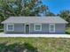 Charming single-story home featuring a gray exterior, a new gray roof, and manicured landscaping at 1415 Southern Ave, Lakeland, FL 33803