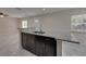Kitchen island featuring a granite countertop and dark wood cabinets in a bright, open-concept space at 1415 Southern Ave, Lakeland, FL 33803