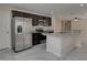 Kitchen with stainless-steel refrigerator and appliances, granite countertops, dark cabinets, and open layout at 1415 Southern Ave, Lakeland, FL 33803