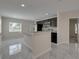 Open-concept kitchen with gray tile flooring, granite countertops and stainless-steel appliances at 1415 Southern Ave, Lakeland, FL 33803