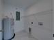 A clean laundry room featuring a water heater, wire shelving, and tile floors at 1415 Southern Ave, Lakeland, FL 33803