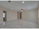 Open floor plan with gray tile flooring leading to bedroom and other rooms at 1415 Southern Ave, Lakeland, FL 33803