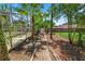 Backyard pathway leads to a screened-in pool, creating an inviting outdoor oasis at 1628 Lakewood S Dr, Lakeland, FL 33813