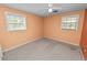 Bedroom with a ceiling fan, neutral walls and carpet, and natural light at 1628 Lakewood S Dr, Lakeland, FL 33813