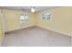 Bright bedroom with plush carpeting, dual windows and neutral color palette at 1628 Lakewood S Dr, Lakeland, FL 33813