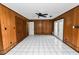 Bonus room with ceiling fan, wood paneling, and tiled floors at 1628 Lakewood S Dr, Lakeland, FL 33813