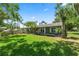 Charming one-story home with a lush green lawn, complemented by mature trees and well-maintained landscaping at 1628 Lakewood S Dr, Lakeland, FL 33813