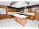 Classic kitchen featuring wood cabinetry, a spacious island, and ample counter space at 1628 Lakewood S Dr, Lakeland, FL 33813