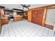 Bright kitchen featuring wood cabinets, tile flooring, and a central island at 1628 Lakewood S Dr, Lakeland, FL 33813