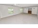 Expansive living room with plush carpeting and natural light from the windows at 1628 Lakewood S Dr, Lakeland, FL 33813