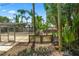 Fenced in pool area. The surrounding palm trees add a tropical vibe to the backyard at 1628 Lakewood S Dr, Lakeland, FL 33813
