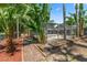 Backyard swimming pool is surrounded by tropical trees and beautiful landscaping at 1628 Lakewood S Dr, Lakeland, FL 33813