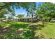 Landscaped side yard with mature trees, shrubbery, and grass at 1628 Lakewood S Dr, Lakeland, FL 33813