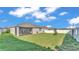 Expansive backyard with lush green grass and a screened-in porch provides serene outdoor living at 1725 Hill Top Dr, Dundee, FL 33838