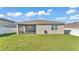 Spacious backyard with a screened lanai offers plenty of room for outdoor activities at 1725 Hill Top Dr, Dundee, FL 33838